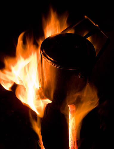 A billy can on top of the fire log. - ©  Gary Waidson - Ravenlore Bushcraft and Wilderness skills.